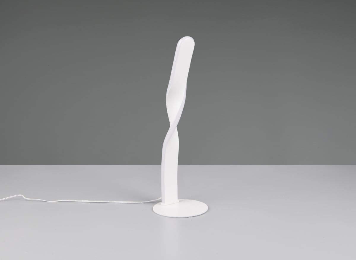 Lampa stołowa Ginko w białym kolorze, wykonana z tworzywa, z charakterystycznym, spiralnym kształtem. Stoi na okrągłej podstawie, z widocznym przewodem zasilającym. Idealna do nowoczesnych aranżacji wnętrz.