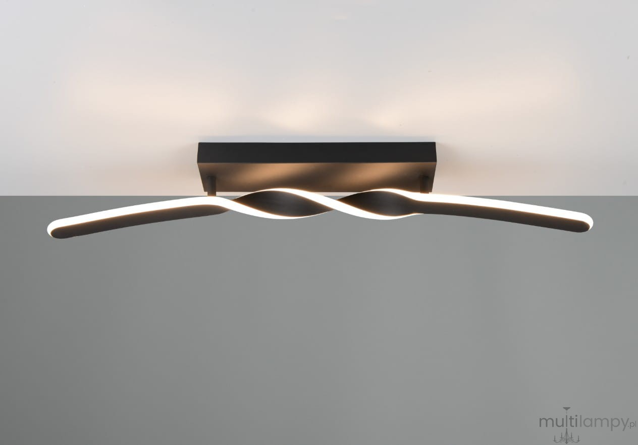 Lampa sufitowa Ginko w kolorze czarnym, z jedną żarówką LED o mocy 18W. Posiada falisty kształt z podświetleniem, montowana do sufitu w pozycji poziomej, na prostokątnym mocowaniu. Tło w jasnym odcieniu.