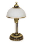 Lampka stołowa Flex O1488 z metalową podstawą w kolorze złotym. Posiada okrągły klosz z białego materiału, z delikatnym wykończeniem. Ujęcie frontalne, lampka stoi na płaskiej powierzchni.