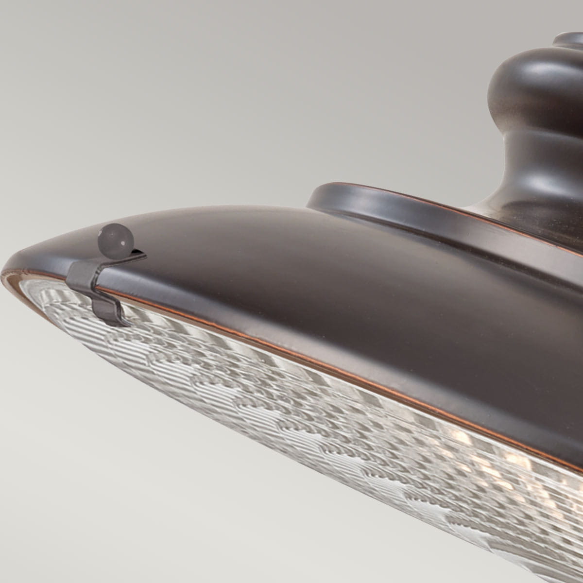 Lampa wisząca Redding Station w kolorze brązowym, z oprawą w kształcie klosza. Widoczna tekstura klosza oraz detal mocowania. Produkt przeznaczony do użytku ogrodowego z gniazdem E27. Ujęcie z boku, pokazujące detale konstrukcyjne.