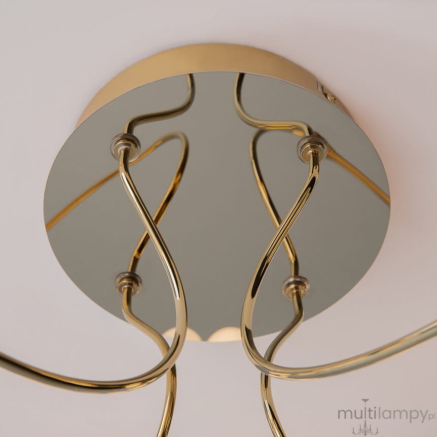 Złota lampa sufitowa LED Tessara z okrągłą podstawą oraz falistymi ramionami. Widok z dołu, ukazujący lustrzaną powierzchnię i eleganckie detale konstrukcji. Wbudowane źródło światła o mocy 55W, barwie 3000K.