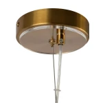Lampa wisząca Arco 3xG9 w kolorze mosiądzu z okrągłym, metalowym kloszem. Widoczny przezroczysty przewód oraz montaż na suficie. Design minimalistyczny, idealny do nowoczesnych wnętrz.