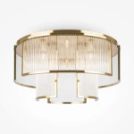 Lampa sufitowa Frame MOD174CL-09G w kolorze złotym z przezroczystymi akrylowymi kloszami. Okrągła forma, z dziewięcioma miejscami na żarówki E14. Zbliżenie na detale, w tym połączenie metalowych elementów z przezroczystymi wstawkami.