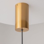 Lampa wisząca LED Imaginary w kolorze złotym, o cylindrycznym kształcie, z metalicznej powierzchni. Posiada czarny kabel zasilający. Ujęcie z dołu, ukazujące mocowanie do sufitu. Ciepła barwa światła 3000K, moc 5W.