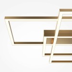 Lampa sufitowa LED Rida o mocy 78W, w kolorze złotym, z nowoczesnym, geometrycznym kształtem. Widoczne są prostokątne ramy z podświetleniem, montowane sufitowo, na jasnym tle.