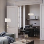 Lampa wisząca Bergamo 5xE27 w kolorze białym, z okrągłym kloszem, zawieszona nad stołem w jadalni. W tle widoczna aranżacja z czarnymi krzesłami i roślinnością na stole. Jasne, neutralne tło podkreśla elegancję lampy.
