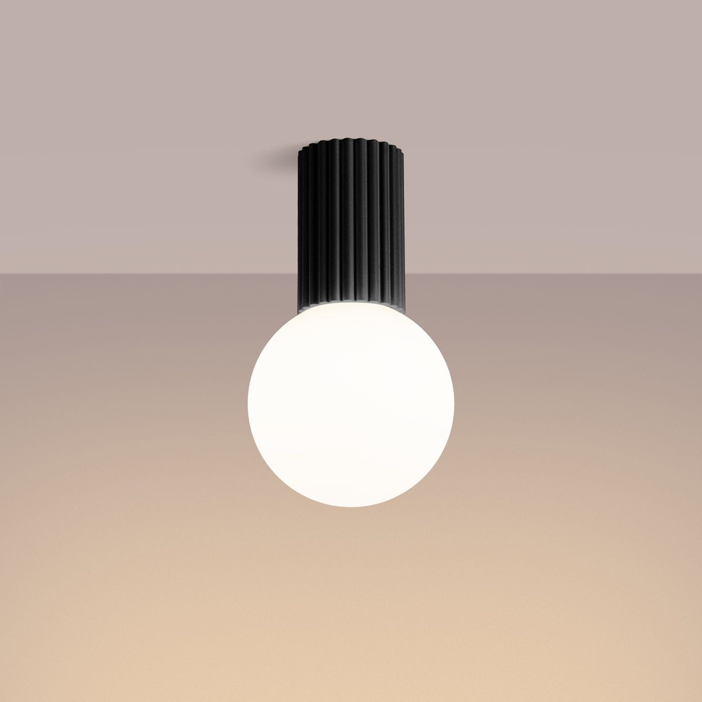 Czarna lampa sufitowa Halo z okrągłym, białym kloszem. Ujęcie z dołu, wisząca na suficie. Posiada żłobioną podstawę, montowana z jedną żarówką G9. Tło w odcieniu beżowym, co podkreśla elegancki design lampy. IP44, odporna na wilgoć.