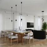 Lampa wisząca Halo w kolorze czarnym, z jedną oprawą G9. Wisi na cienkich linkach, obok białych kulistych żarówek. Znajduje się w nowoczesnym wnętrzu z drewnianym stołem i jasnymi zasłonami.