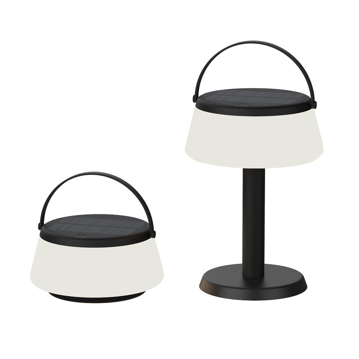 Czarna lampa stołowa solarna LED Aure z białym abażurem, moc 2,2W, barwa światła 2700K, klasa szczelności IP44. Ujęcie pokazuje lampę stojącą oraz przenośną z uchwytem. Prosta, nowoczesna forma, przeznaczona do użytku wewnętrznego i zewnętrznego.