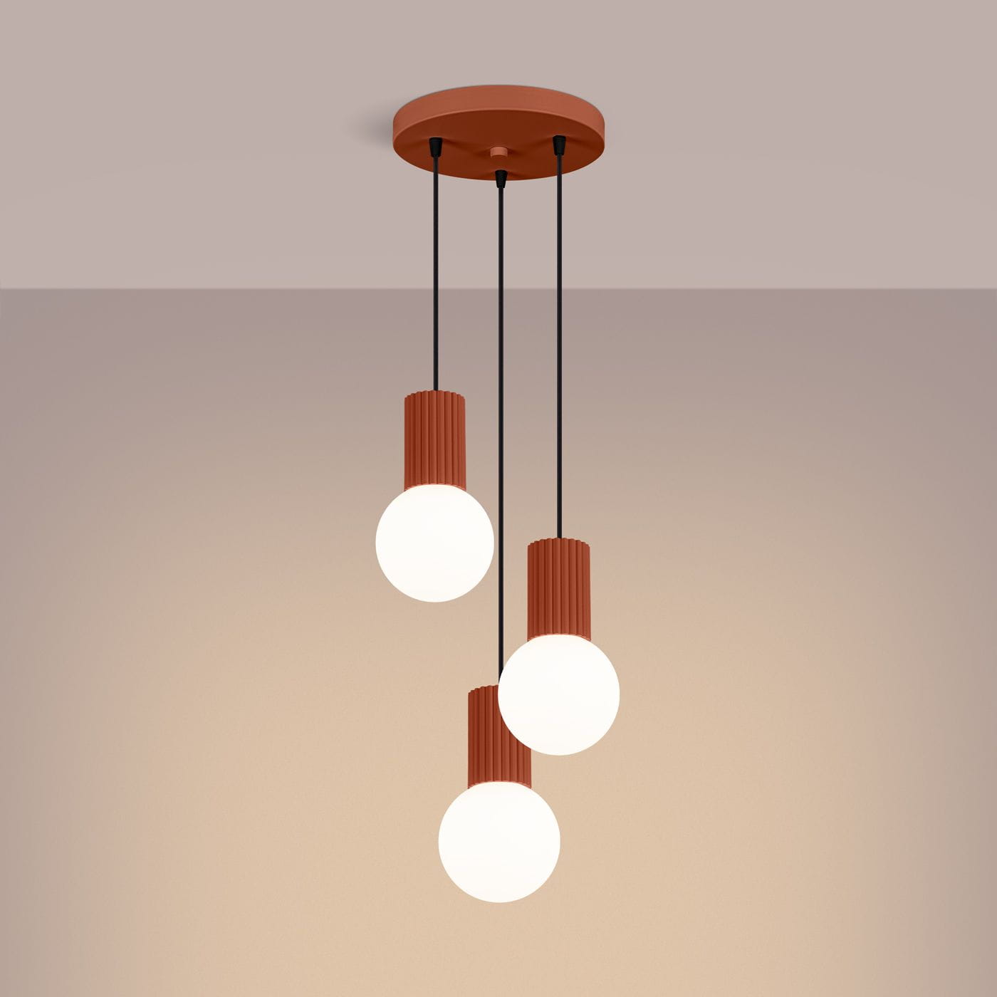 Lampa wisząca Halo 3xG9 w kolorze ochra czerwona, z trzema okrągłymi, białymi kloszami zawieszoną na czarnych przewodach. Wysoka, teksturowana podstawa w kolorze ochry. Produkt umieszczony na jednolitym tle.