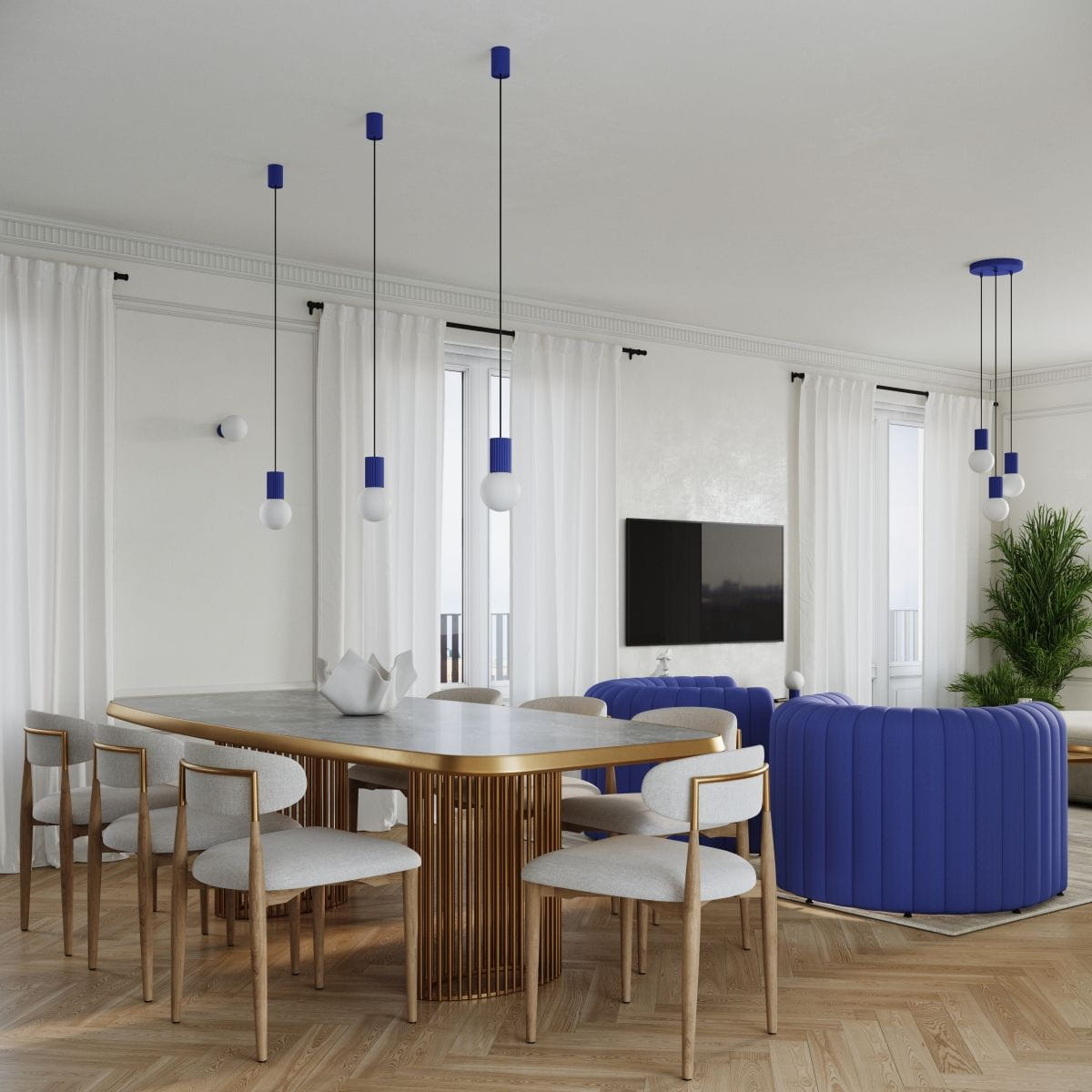 Lampa wisząca Halo 1xG9 w kolorze niebieskim, z okrągłymi kloszami i elementami w kolorze niebieskim, zawieszona na cienkich czarnych linkach. Wnętrze w nowoczesnym stylu z jasnym stołem i krzesłami w tle.