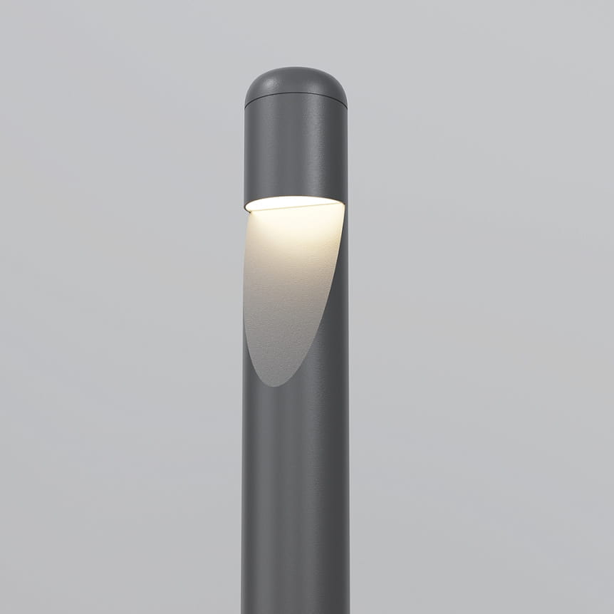Grafitowa lampa ogrodowa LED Hagen H60, moc 5W, barwa światła 3000K. Stojąca, z okrągłym kloszem, emitująca ciepłe światło. Ujęcie z boku, ukazujące detal oświetlenia. Prosta, nowoczesna forma, idealna do aranżacji ogrodowych.