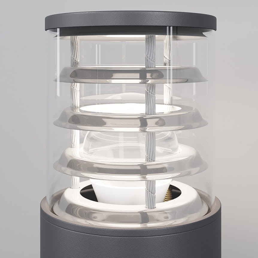 Lampa ogrodowa Bronx H25 w kolorze grafitowym, z jedną oprawą E27. Przezroczysta osłona z warstwami tworzywa, z widocznym źródłem światła w dolnej części. Stojąca konstrukcja, elegancki design, idealna do oświetlenia przestrzeni zewnętrznych.