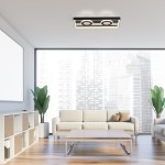 Lampa sufitowa Traforo LED 20W CCT w kolorze czarnym, montowana na suficie. Posiada dwa okrągłe źródła światła, zdalne sterowanie. W tle nowoczesny salon z jasnym umeblowaniem oraz dużymi oknami.