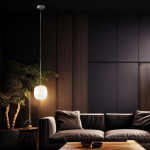 Lampa wisząca LED Vaso 2 l, 4W, 3000K, biała, zawieszona na cienkim przewodzie w nowoczesnym wnętrzu. Oświetlenie emituje ciepłe światło, a tło stanowi ciemna ściana oraz wygodna, ciemna kanapa. W pobliżu roślina doniczkowa.