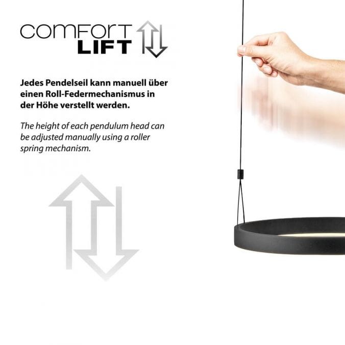 Lampa wisząca Esko z pilotem, czarna. Dwa źródła światła LED 46W CCT. Widoczna ręka regulująca wysokość lampy za pomocą mechanizmu sprężynowego. Prosta konstrukcja z okrągłym kloszem. Tło jasne, minimalistyczne.