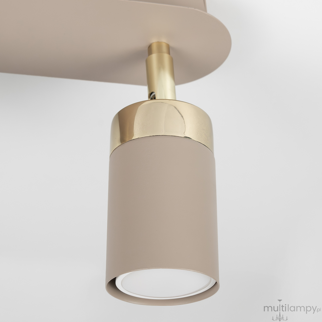 Lampa sufitowa Joker w kolorze kaszmiru z metalowym złotym wykończeniem, z dwoma spotami na żarówki GU10. Ujęcie z bliska, pokazujące detal lampy oraz jej cylindryczny kształt. Tło białe, minimalistyczne.