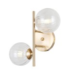 Kinkiet Toledo w kolorze złotym, z dwiema przezroczystymi kulistymi kloszami. Ułożony w pionie na okrągłej podstawie, z wyraźną teksturą kloszy. Oświetlenie na dwie żarówki G9, nowoczesny design idealny do wnętrz.
