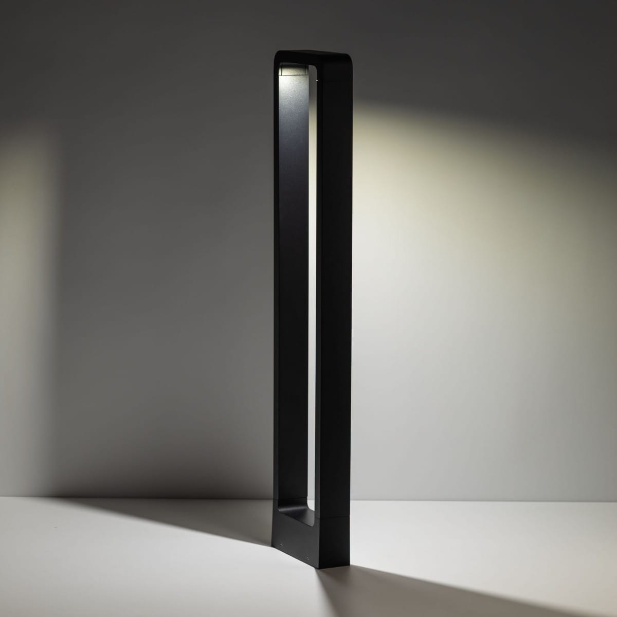 Lampa stojąca ogrodowa Rio LED H80 w kolorze czarnym, o prostokątnym kształcie. Ujęcie z boku, ukazujące subtelne podświetlenie. Wykonana z metalu, z minimalistycznym designem, idealna do oświetlenia przestrzeni zewnętrznych.