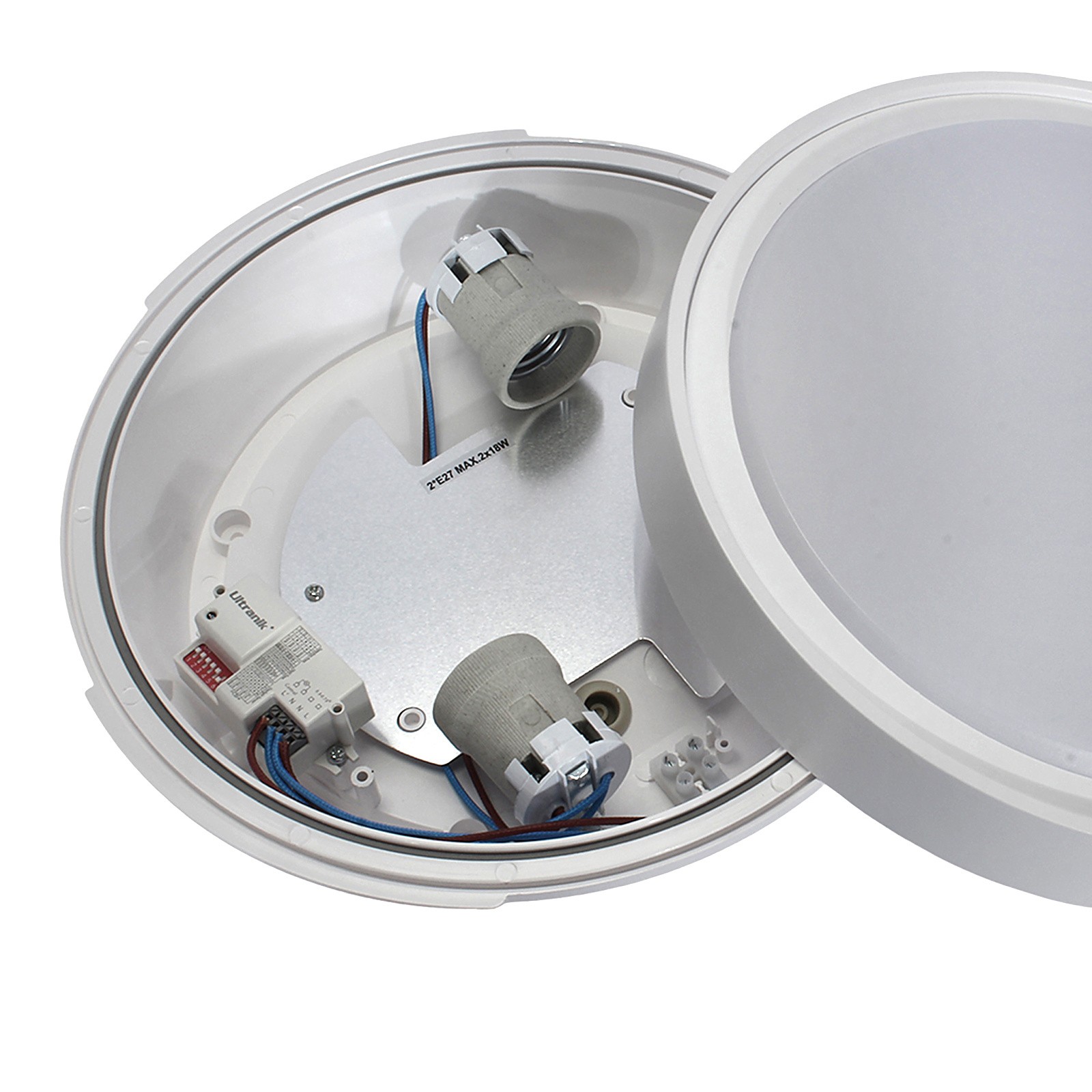 Lampa sufitowa Rotonda zewnętrzna w kolorze białym, z miejscem na dwa gwinty E27. Widok z góry, ukazujący wnętrze lampy z czujnikiem ruchu, przewodami oraz metalową podstawą. Okrągły kształt z przezroczystą osłoną.