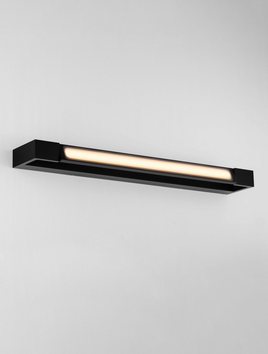 Kinkiet Justo 1xLED 17W w kolorze czarnym, prostokątny, zamontowany na ścianie. Posiada matowy klosz z białego szkła, emitujący ciepłe światło. Minimalistyczny design, idealny do nowoczesnych wnętrz.