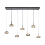 Lampa wisząca Rika z siedmioma kloszami LED 56W w czarnym dymionym kolorze. Klosze o okrągłym kształcie zawieszone na cienkich linkach z metalowym stelażem. Produkt wisi na prostokątnej podsufitce, idealny do nowoczesnych wnętrz.