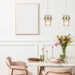 Lampa wisząca Vetro LP-2910/2L GD z dwoma źródłami E14, złota, z przezroczystym kloszem. Zawieszona w nowoczesnym wnętrzu, nad stołem. W tle białe ściany, stół z zastawą, świecami i bukietem kwiatów.
