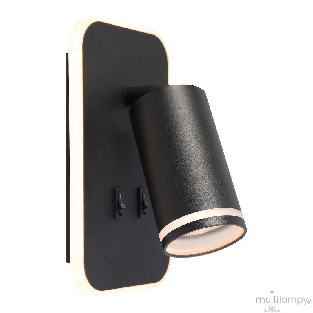 Kinkiet Pipe Ring w kolorze czarnym z jedną oprawą GU10 i wbudowanym LED 6W. Lampa ma cylindryczny klosz z delikatnym wykończeniem w kolorze złotym oraz dwa włączniki na ścianie. Montaż na płaskiej, prostokątnej podstawie.
