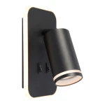 Kinkiet Pipe Ring w kolorze czarnym z jedną oprawą GU10 i wbudowanym LED 6W. Lampa ma cylindryczny klosz z delikatnym wykończeniem w kolorze złotym oraz dwa włączniki na ścianie. Montaż na płaskiej, prostokątnej podstawie.