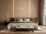 Lampa wisząca Jauja 2xLED 87W w kolorze złotym, o nowoczesnym kształcie, zawieszona nad łóżkiem w sypialni. Tło w odcieniach beżu, z drewnianymi elementami i roślinnością, tworzy przytulną atmosferę.