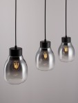 Lampa wisząca Moche w kolorze czarnym z trzema kloszami w kształcie szklanych pojemników. Każdy klosz zawiera żarówkę E27. Zawieszona na czarnych linkach, minimalistyczny design, idealna do nowoczesnych wnętrz. Tło jasne, jednolite.