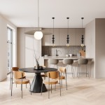 Lampa wisząca Tower 1xE27 w kolorze czarnym, z okrągłym kloszem i metalowym talerzem, zawieszona nad okrągłym stołem w nowoczesnej kuchni. W tle widoczne inne lampy oraz meble w stonowanych kolorach.