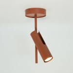 Lampa sufitowa Leda w kolorze ceglastym, z pojedynczym spotem GU10, umieszczona pod kątem. Metalowa konstrukcja z otwartym wlotem, montowana do sufitu, z prostym, minimalistycznym designem.