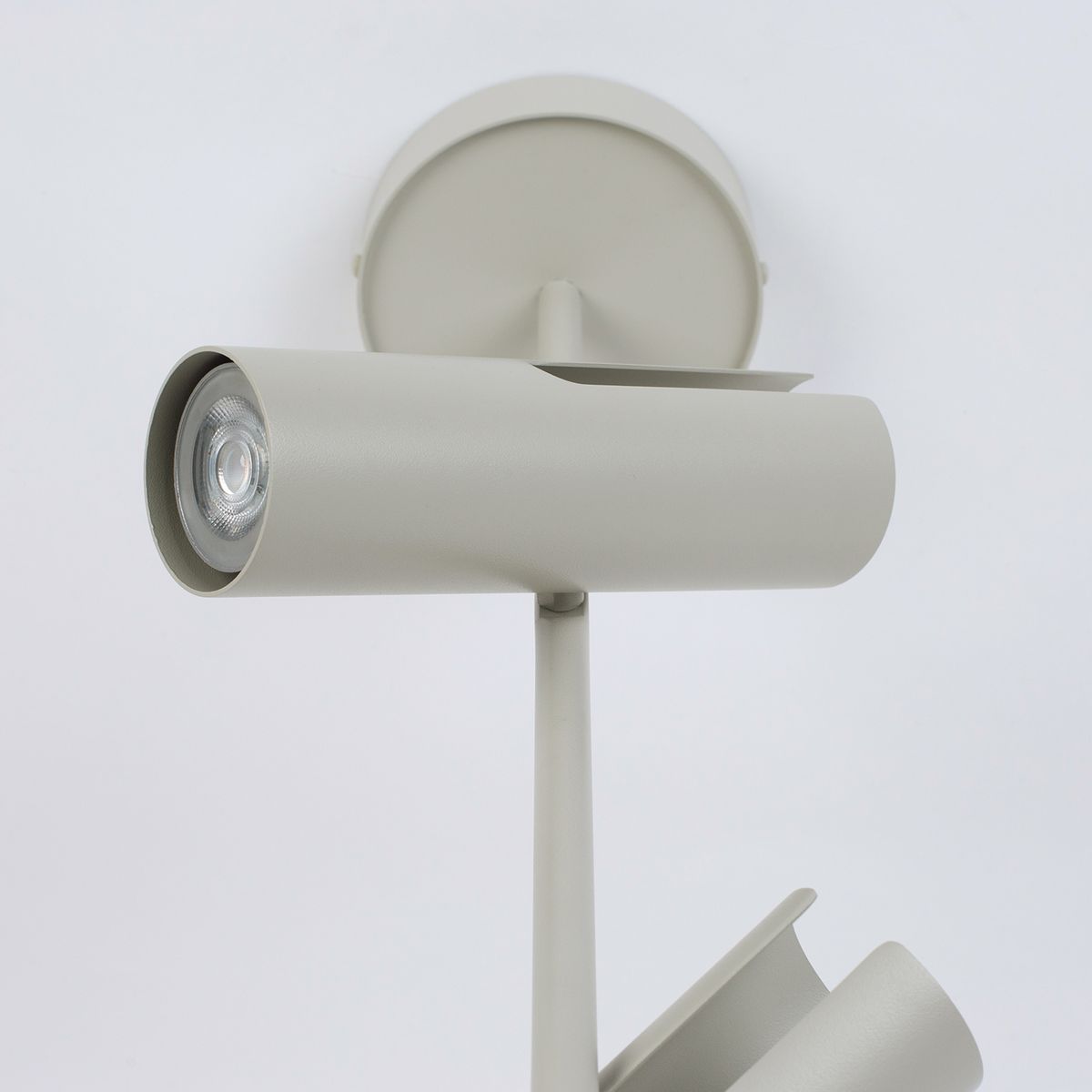 Lampa wisząca Leda 2xGU10 w kolorze szarym beżowym, z cylindrycznymi kloszami. Ukazana z boku, z widoczną pojedynczą oprawą i okrągłą podstawą montażową na tle białym. Prosta, minimalistyczna forma i teksturowana powierzchnia.