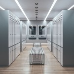 Opti oprawa sufitowa do zabudowy 1xGU10 IP64 w kolorze czarnym, zamontowana w suficie, z widocznymi okrągłymi wlotami, w nowoczesnej przestrzeni z szafkami, lustrem i umywalkami, na tle jasnego wnętrza.