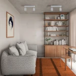 Lampa sufitowa Nex, biała, z dwoma reflektorami GU10, zamontowana na suficie w nowoczesnym wnętrzu. W tle widoczna szara sofa, regał z książkami oraz drewniane meble. Proste tło sprzyja wyróżnieniu lampy.