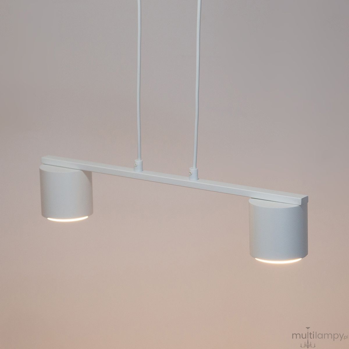 Lampa wisząca Mila 2xGX53 w kolorze białym, o minimalistycznym designie. Składa się z dwóch cylindrycznych kloszy zawieszonych na prostej belce. Ujęcie z przodu, pokazujące zawieszenie i równą linię. Idealna do nowoczesnych wnętrz.