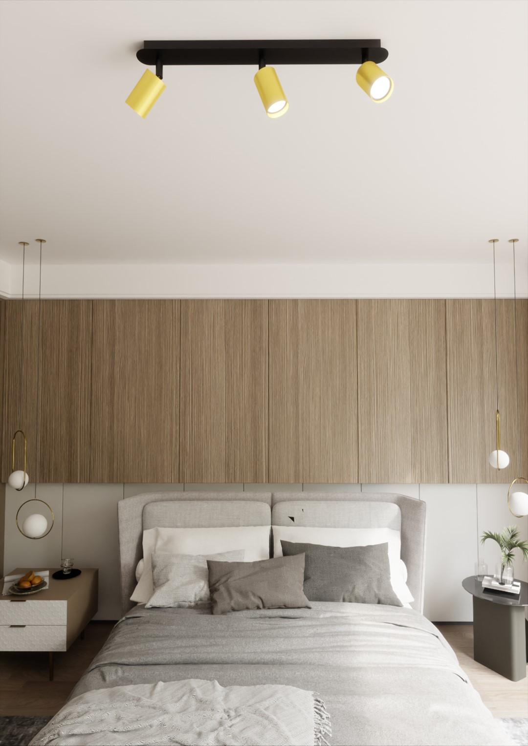 Czarna lampa sufitowa 3-punktowa Zen z żółtymi kloszami, zamontowana na drewnianym suficie, skierowana w dół. Lampa znajduje się nad łóżkiem z szarymi poduszkami, w nowoczesnej sypialni z jasnym tłem.