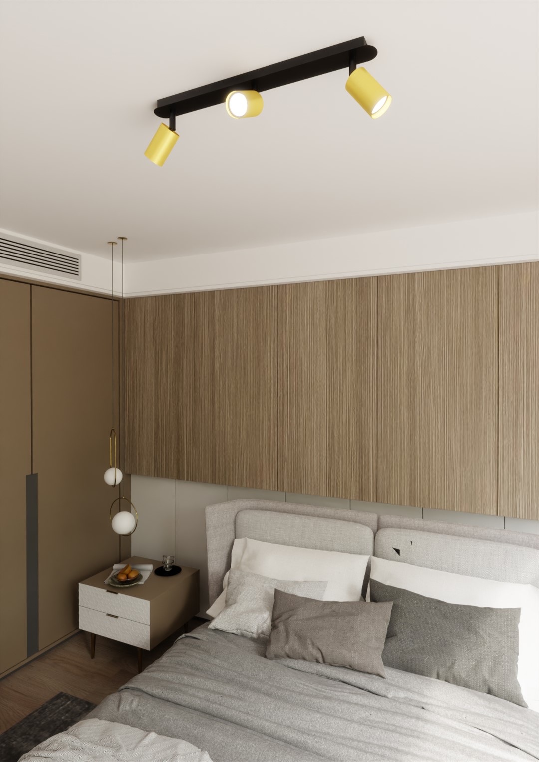 Czarna lampa sufitowa 3-punktowa Zen z trzema żółtymi reflektorami, zamontowana na suficie. Oświetlenie skierowane w dół, w nowoczesnej sypialni z jasnymi ścianami i drewnianymi akcentami.
