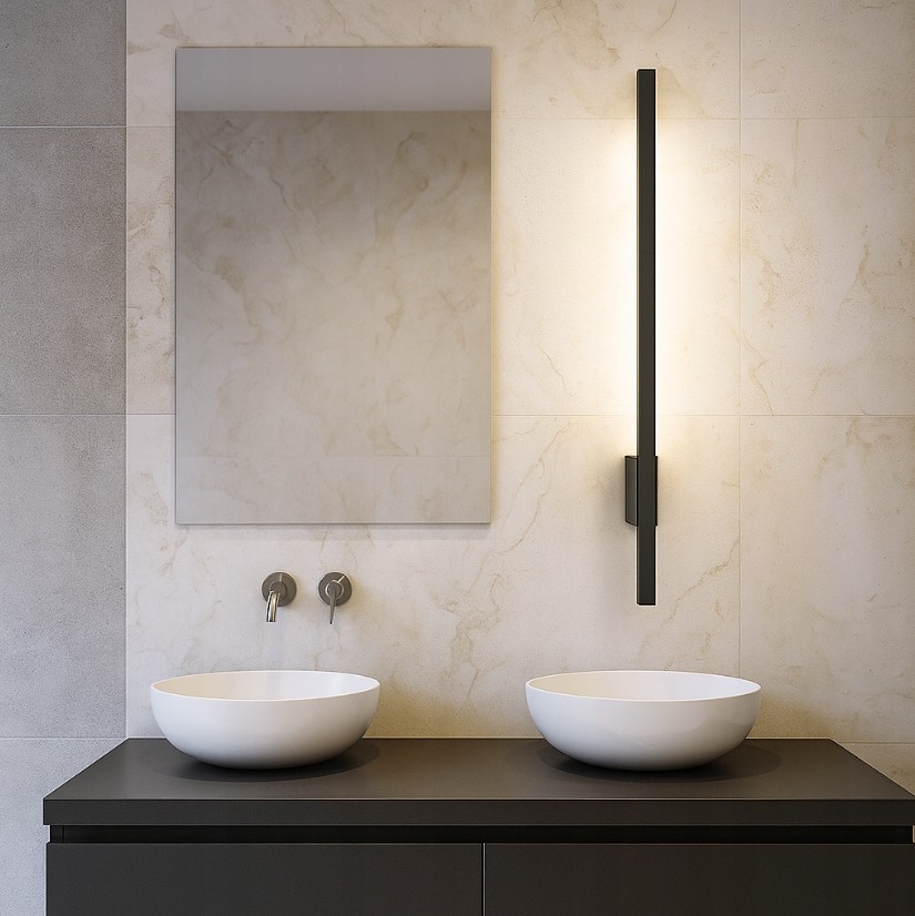 Linera kinkiet elewacyjny LED 9W 4000K w kolorze czarnym, zamontowany na ścianie. Produkt ma prostokątny kształt, emitując ciepłe światło. W tle widoczna umywalka i lustro, całość w aranżacji łazienkowej.