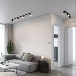 Lampa sufitowa podtynkowa Amis w kolorze czarnym z trzema reflektorami typu GU10. Ujęcie z góry, zamontowana na suficie, oświetla przestrzeń nad sofą w nowoczesnym wnętrzu. W tle widoczny kaktus i stół z dekoracjami.