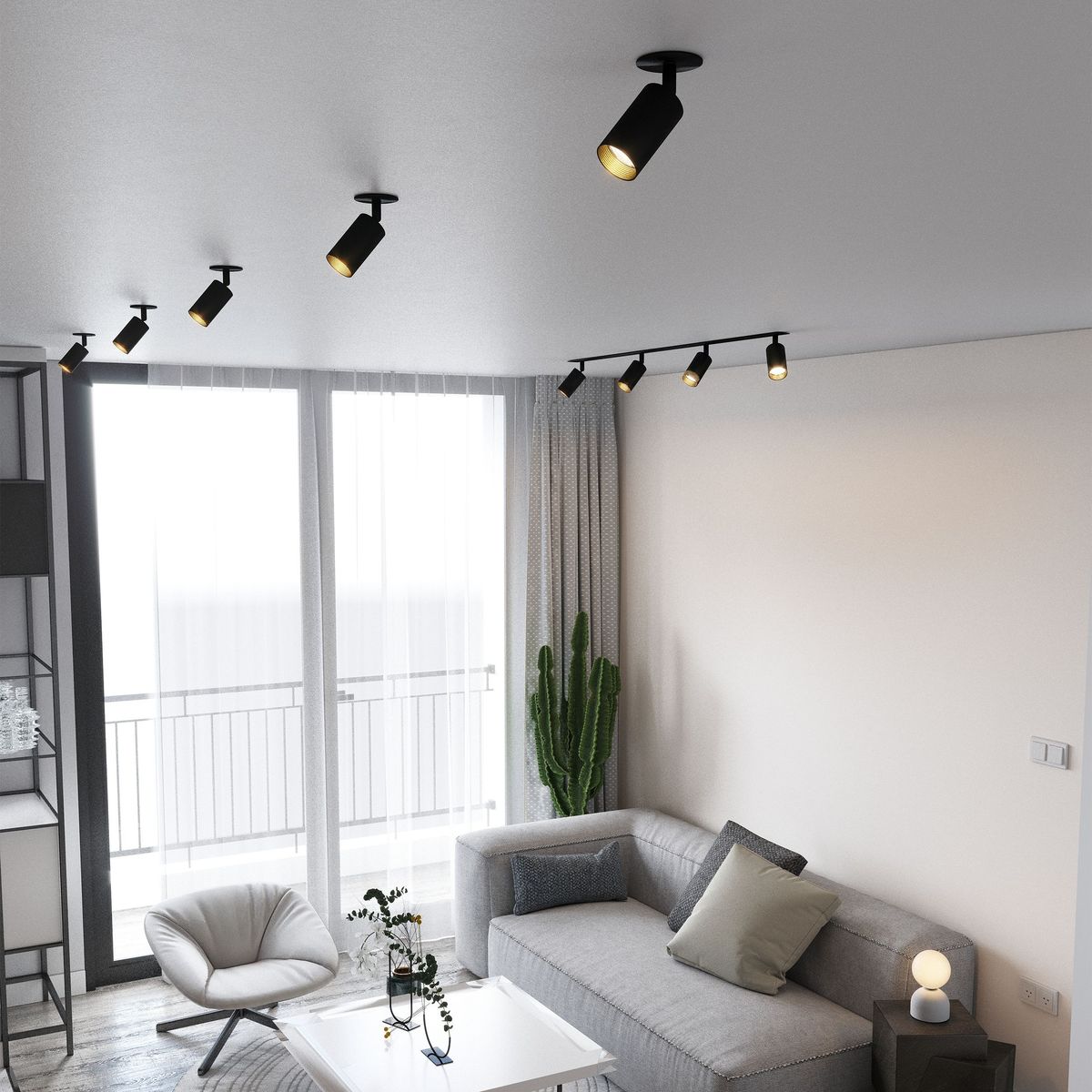 Lampa sufitowa podtynkowa Amis w kolorze czarnym z jednym źródłem światła GU10. Ujęcie z góry, pokazujące lampę zamontowaną w nowoczesnym wnętrzu, z sofą i roślinnością w tle.