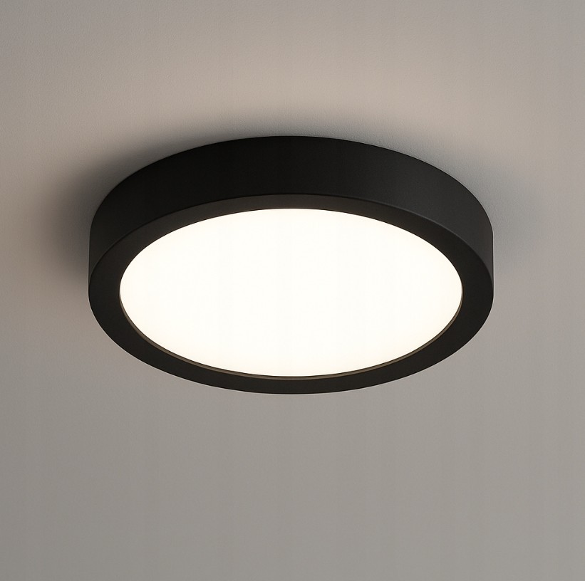 Panel LED natynkowy o okrągłym kształcie, czarny, z białym źródłem światła o mocy 18W i temperaturze barwowej 4000K. Zainstalowany na suficie, o prostym, nowoczesnym designie.