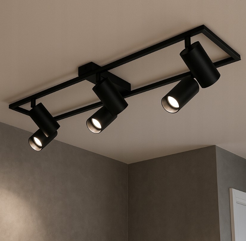 Czarna lampa sufitowa Bumo z sześcioma reflektorami GU10, zamontowana na prostokątnej ramie. Reflektory skierowane w różne strony, umieszczone na suficie w minimalistycznym stylu. Tło w odcieniach szarości.