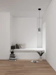Czarna lampa wisząca Anuco z jedną diodą LED 3W, o cylindrycznym kształcie, zawieszona na cienkim przewodzie. Lampa znajduje się w minimalistycznym wnętrzu z łóżkiem, książkami i rośliną w wazonie. Tło jest jasne, co podkreśla jej nowoczesny design.