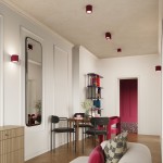 Lampa sufitowa Aura 1xGU10 w kolorze burgundowym, o cylindrycznym kształcie z fakturą poziomych rowków. Zainstalowana na suficie w nowoczesnym wnętrzu, w otoczeniu mebli i dekoracji, zapewnia stylowe oświetlenie przestrzeni.