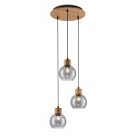 Lampa wisząca Velma z trzema kloszami w kształcie kul, wykonana z przezroczystego szkła i drewnianymi elementami. Zawieszona na cienkich, czarnych kablach, mocowana do okrągłej, drewnianej podstawy. Idealna do nowoczesnych wnętrz.