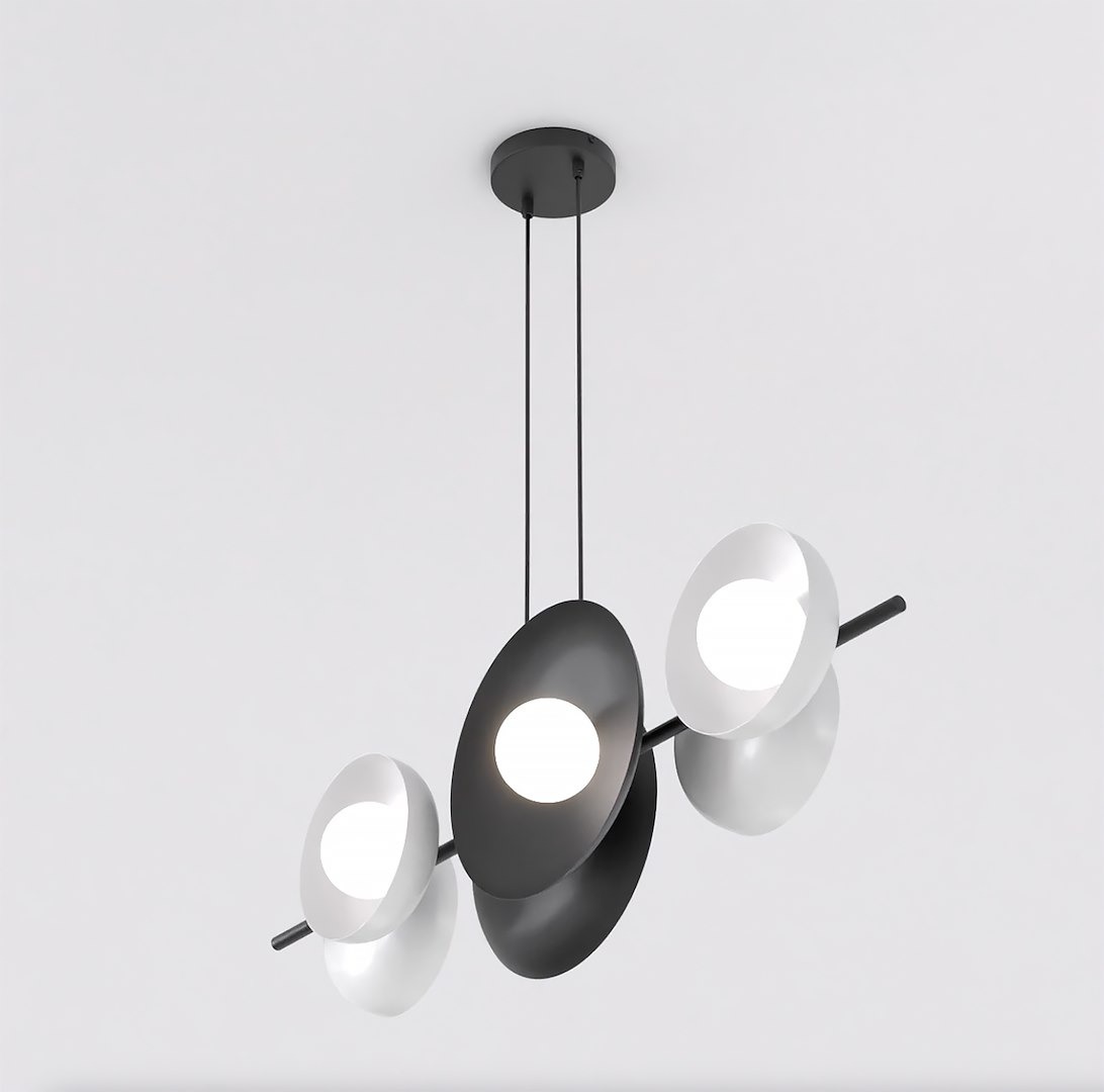 Lampa wisząca Volum z sześcioma źródłami światła G9, w kolorze czarnym i białym. Posiada asymetryczne, owalne klosze, zawieszona na dwóch linkach pod sufitem. Klosze w białym i czarnym kolorze z centralnym źródłem światła. Prosty, nowoczesny design.