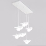Lampa wisząca Ritual 1584/6 w białym kolorze, z sześcioma oprawami G9, zawieszona na białym panelu sufitowym. Każda oprawa ma kształt półkulisty z płaskimi brzegami, zwisające na cienkich linkach. Tło w odcieniu szarym.