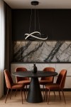 Czarna lampa wisząca Fondi z jednym źródłem światła LED 40W CCT, zawieszona nad okrągłym stołem. Tło w odcieniach czerni i bieli, z marmurowym blatem oraz ciepłymi brązowymi krzesłami.